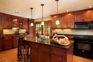 ideas-kitchen-eye-catching-three-funnel-pendant-island-light-over-small-brown-kitchen-island-black-granite-top-as-well-as-brown-mahogany-kitchen-cabinet-as-inspiring-traditional-small-kitchen-design
